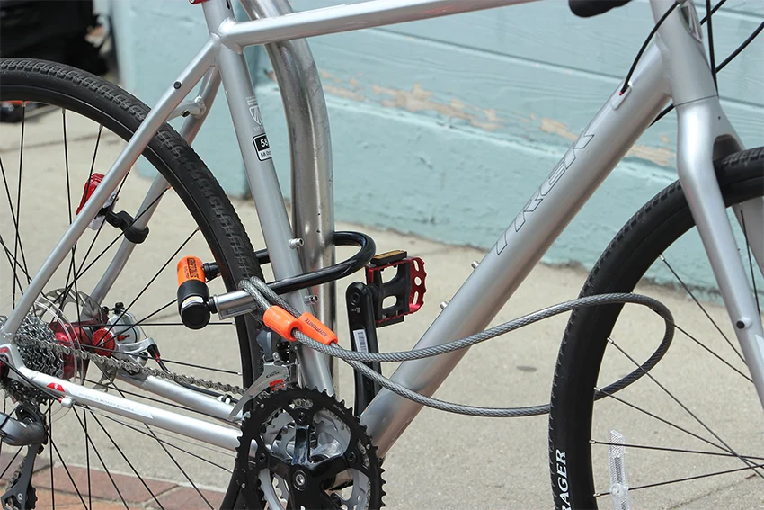 gray bike locked with a u-lock