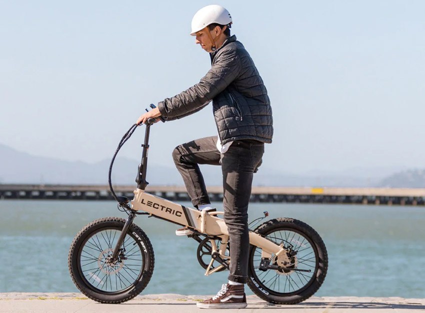 man riding lectric lightweight bicycle