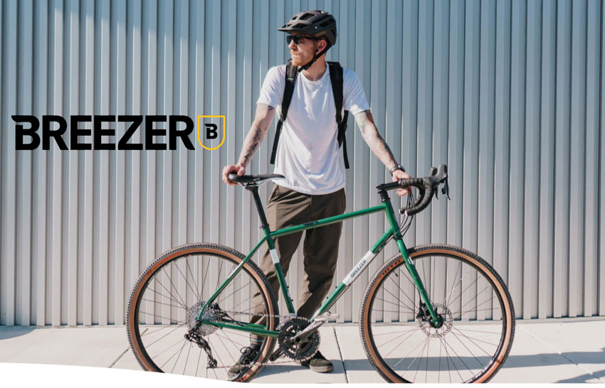 man standing with a breezer bike