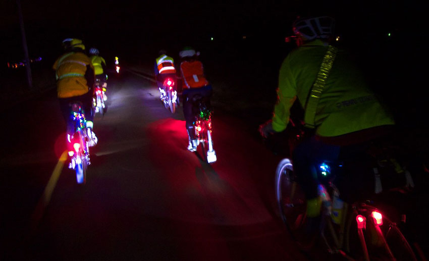 cyclists riding their bikes at night