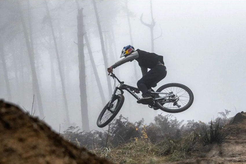 rider jumping with alpine trail enduro bike