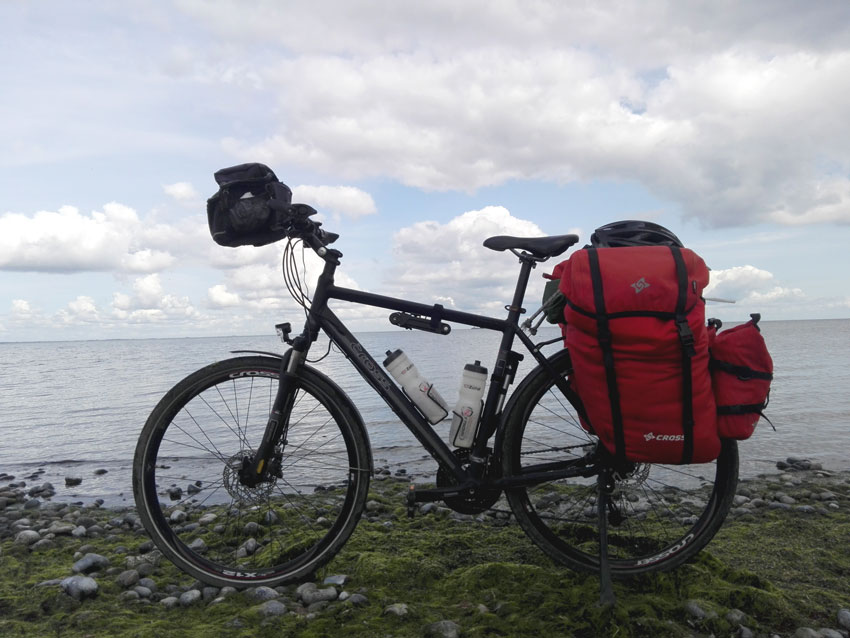touring bicycle with red panniers