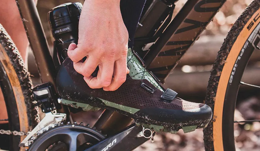 man tightening boa strap on his best gravel bike shoes