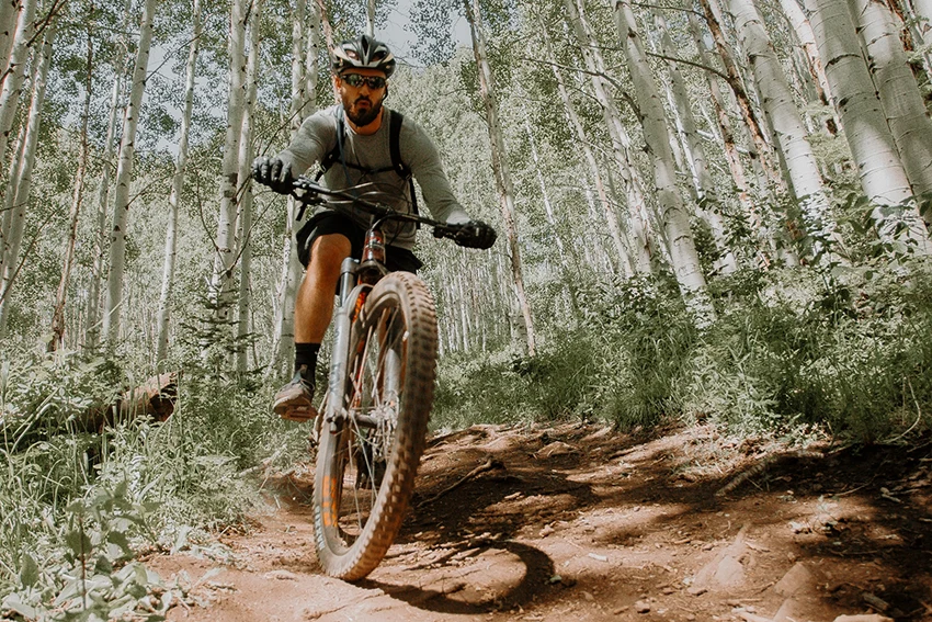 cyclist descending a steep hill on a 29-inch mountain bike