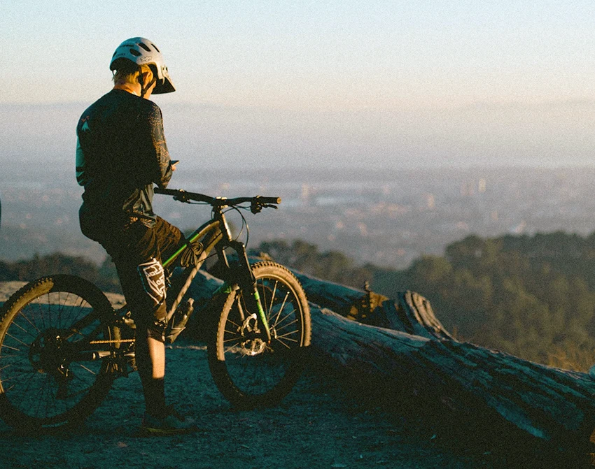 rider sitting on a 29er mountain bike next to a ledge