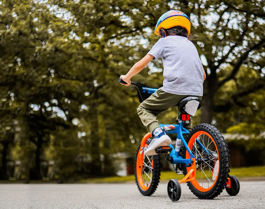 boy riding a kids bike pictured from behind