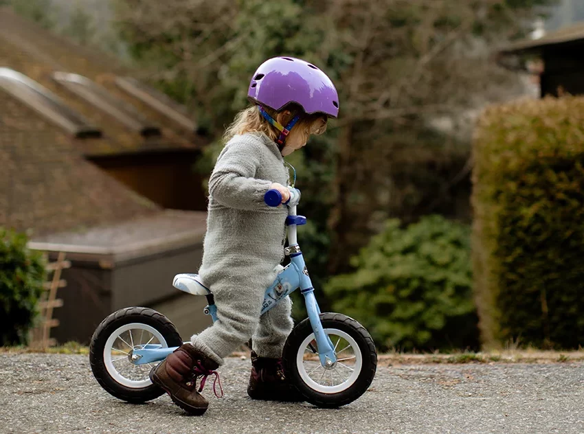 small girl riding a balance bike