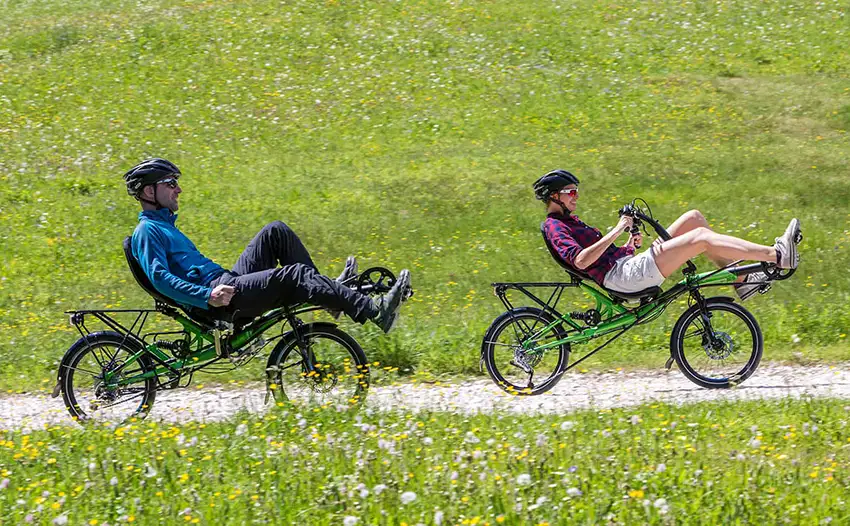 man and woman exercising on recumbent bikes