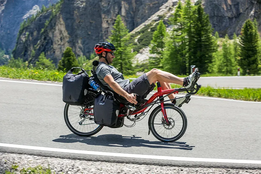 man riding a recumbent bike in the mountains