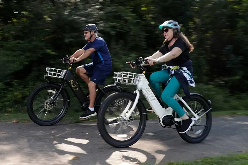 man and woman riding buzz cerana electric bicycles