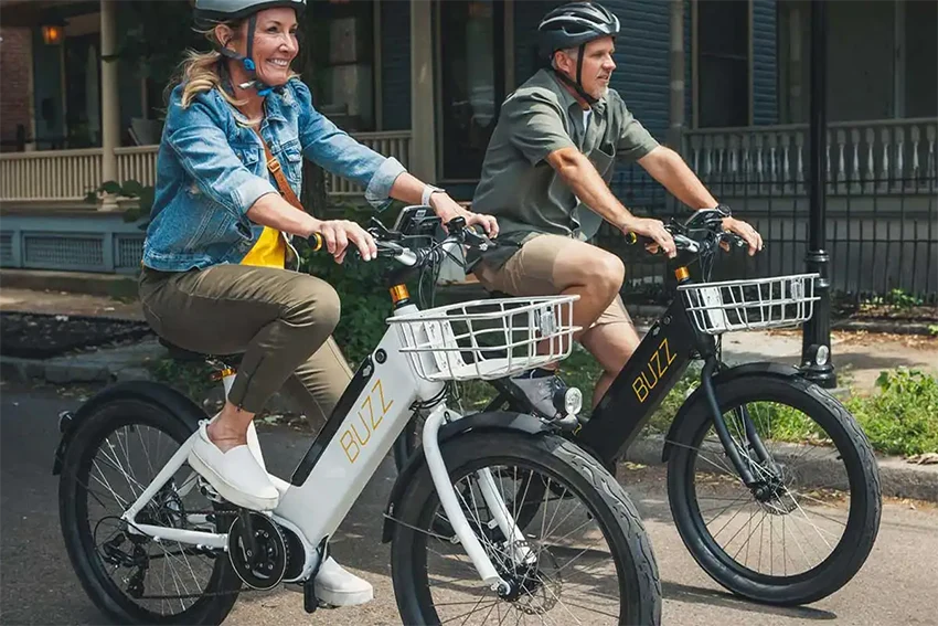 man and woman riding buzz electric bikes