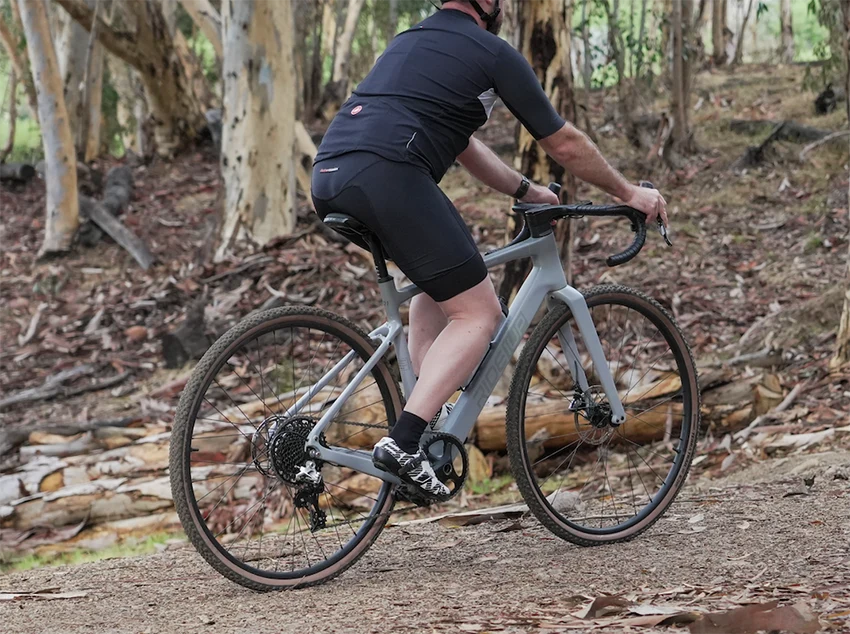 man riding ride1up cf racer1 ebike in a forest