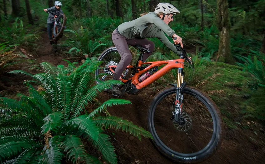 man and woman riding specialized trail mountain bikes